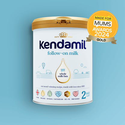 A tin of Classic Follow-On Milk with a gold Made for Mums Awards 2024 badge on a blue background. The tin displays icons showing it is made from whole milk formula, is vegetarian, contains plant-based DHA, and is suitable for babies aged 6-12 months.