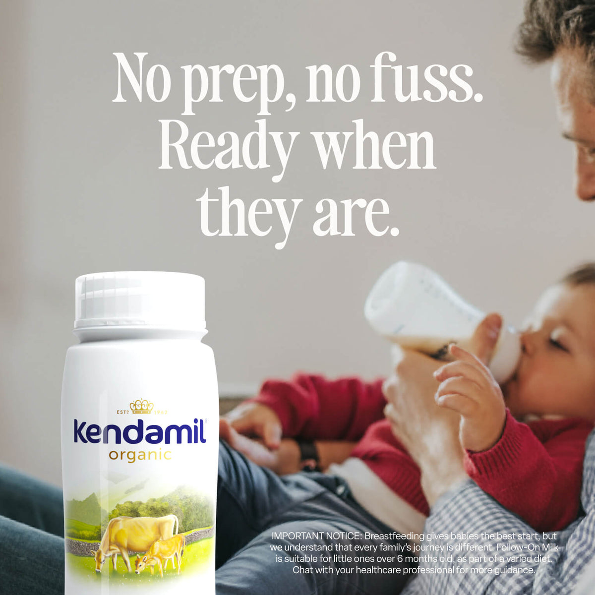 A caregiver feeds a baby with a bottle while sitting on a couch. In the foreground, there is a container of 6x200ml Organic Ready to Feed Follow On Milk, made from grass-fed cows. Text above reads: No prep, no fuss. Ready when they are.