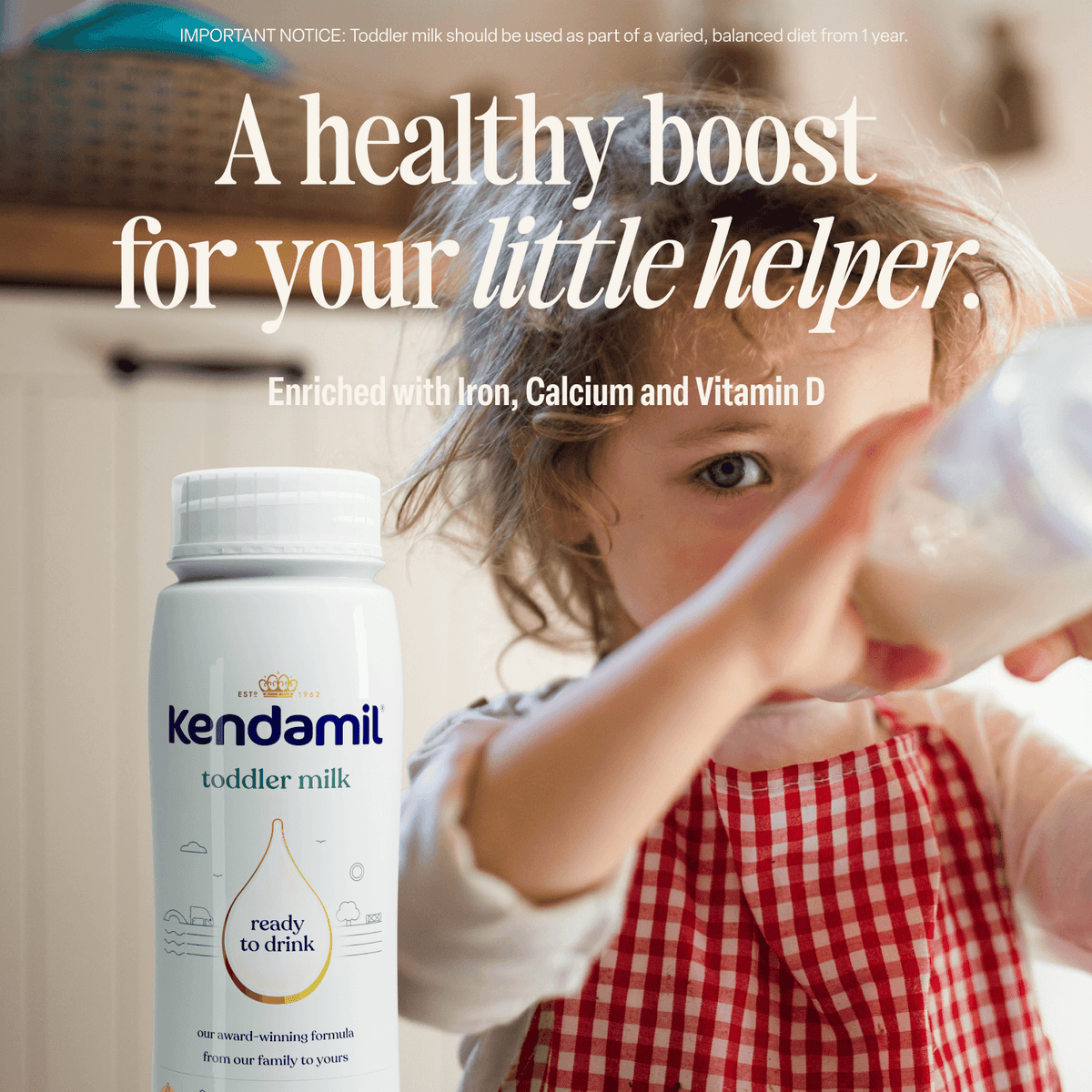 A child in a red-and-white plaid apron holds a glass; in the foreground sits a bottle of 6x200ml Classic Ready to Feed Toddler Milk, made from whole milk. Text reads, A healthy boost for your little helper.